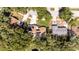 This is an aerial view of a home, with mature trees, a lawn, a driveway, and a swimming pool at 5177 Chesapeake Ave, Orlando, FL 32808