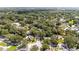 Wide aerial view showcasing a neighborhood with mature trees, homes, and well maintained streets at 5177 Chesapeake Ave, Orlando, FL 32808