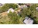 This is an aerial view of a home, with mature trees, a lawn, a driveway, and a swimming pool at 5177 Chesapeake Ave, Orlando, FL 32808