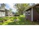 Inviting backyard featuring a wooden deck and shed on a well-maintained lawn at 5177 Chesapeake Ave, Orlando, FL 32808