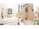 Bathroom features a tub, shower, vanity, toilet, and a mirrored cabinet for storage at 5177 Chesapeake Ave, Orlando, FL 32808