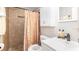 Bathroom featuring a step-in shower with neutral tile, a patterned shower curtain, and a vanity with toiletries at 5177 Chesapeake Ave, Orlando, FL 32808
