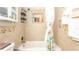 Bright bathroom featuring a bathtub with a shower, tiled walls, and a floral shower curtain at 5177 Chesapeake Ave, Orlando, FL 32808