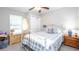 Cozy bedroom with soft gray walls, a white metal bed frame, and a plush throw pillow with the words 