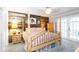 Comfortable bedroom featuring a four-poster bed, a rustic wooden accent wall, and French doors leading to the outside at 5177 Chesapeake Ave, Orlando, FL 32808