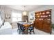 Cozy dining area features a charming table setting, decorative hutch, and natural light that creates a welcoming atmosphere at 5177 Chesapeake Ave, Orlando, FL 32808