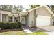 A welcoming front entrance with a decorative door, manicured shrubs, and a paved walkway leading to the home at 5177 Chesapeake Ave, Orlando, FL 32808