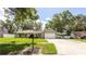 Inviting home with lush green lawn, mature trees, a carport, and a charming mailbox, creating curb appeal at 5177 Chesapeake Ave, Orlando, FL 32808