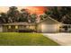 Charming single-Gathering home with a well-manicured lawn, front shrubs, and an attached two-car garage at 5177 Chesapeake Ave, Orlando, FL 32808