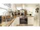 Bright kitchen with granite countertops, stainless steel oven, range hood, and white cabinets at 5177 Chesapeake Ave, Orlando, FL 32808