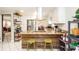 Open kitchen with bar stool seating at the island with granite countertop and stainless steel appliances at 5177 Chesapeake Ave, Orlando, FL 32808