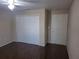 Cozy bedroom featuring wood floors, ceiling fan, and closet with double doors at 5459 Vineland Rd # 4310, Orlando, FL 32811