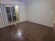 The spacious living room features hardwood floors and a sliding glass door to the balcony at 5459 Vineland Rd # 4310, Orlando, FL 32811