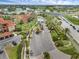 Aerial view of the property with palm-lined streets, lush landscaping, and a glimpse of a nearby lake at 5512 Metrowest Blvd # 201, Orlando, FL 32811