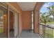 Balcony with sliding glass door, palm trees and a view of the grounds at 5512 Metrowest Blvd # 201, Orlando, FL 32811