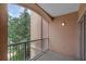 Balcony with an arched ceiling overlooking mature trees at 5512 Metrowest Blvd # 201, Orlando, FL 32811