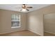 Bedroom with neutral walls, ceiling fan, wood floors, and walk in closet at 5512 Metrowest Blvd # 201, Orlando, FL 32811