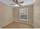 Cozy bedroom with wood floors, ceiling fan, and closet at 5512 Metrowest Blvd # 201, Orlando, FL 32811