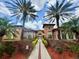 Community clubhouse with palm trees, meticulous landscaping, and an inviting entrance, perfect for social gatherings at 5512 Metrowest Blvd # 201, Orlando, FL 32811