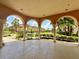 Outdoor common area featuring arched walkways, manicured landscaping, and a view of the community at 5512 Metrowest Blvd # 201, Orlando, FL 32811