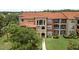 Condo building with tile roof, balconies and manicured lawn at 5512 Metrowest Blvd # 201, Orlando, FL 32811