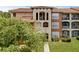 Exterior view of building with Spanish-style tile roof and well-kept grounds at 5512 Metrowest Blvd # 201, Orlando, FL 32811