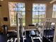 Well-lit fitness center featuring modern exercise equipment and large windows overlooking the community at 5512 Metrowest Blvd # 201, Orlando, FL 32811