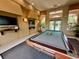 Inviting game room with a billiards table, TV, and comfortable seating for entertainment at 5512 Metrowest Blvd # 201, Orlando, FL 32811