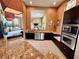 Community kitchen with granite countertops, stainless steel appliances, and ample counter space at 5512 Metrowest Blvd # 201, Orlando, FL 32811