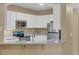 Contemporary kitchen with modern appliances, granite countertops, ample storage, and convenient breakfast bar seating at 5512 Metrowest Blvd # 201, Orlando, FL 32811