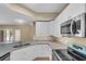 Updated kitchen features granite countertops, stainless appliances, and ample cabinet space at 5512 Metrowest Blvd # 201, Orlando, FL 32811