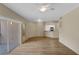 Spacious living room featuring modern lighting, wood floors, and seamless access to the kitchen and outdoor balcony at 5512 Metrowest Blvd # 201, Orlando, FL 32811