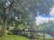 View of the community pool from behind a black metal fence at 6100 Stevenson Dr # 207, Orlando, FL 32835