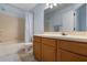 Bathroom with a tub, shower, and vanity with wood cabinets at 685 Youngstown Pkwy # 300, Altamonte Springs, FL 32714