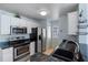 Well-equipped kitchen with stainless steel appliances, granite countertops and white cabinetry at 685 Youngstown Pkwy # 300, Altamonte Springs, FL 32714