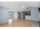 Open living space with a ceiling fan, wood floors, and a partial view into the kitchen at 685 Youngstown Pkwy # 300, Altamonte Springs, FL 32714