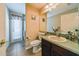 Standard bathroom featuring a vanity with sink, toilet, shower and access door to a covered outdoor space at 742 Seneca Trl, St Cloud, FL 34772