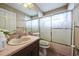 Bathroom featuring a vanity with sink, toilet, and shower-tub combo with glass doors at 742 Seneca Trl, St Cloud, FL 34772