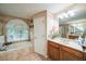 Bathroom featuring a soaking tub, vanity with sink, and a window at 742 Seneca Trl, St Cloud, FL 34772