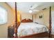 Guest bedroom with a dark wood, four poster bed, ceiling fan, and a window for natural light at 742 Seneca Trl, St Cloud, FL 34772