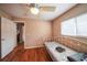 Spare bedroom with hardwood floors, window, ceiling fan, and a daybed at 742 Seneca Trl, St Cloud, FL 34772