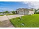 Exterior shot of home featuring a three-car garage, landscaping, and a well-kept lawn at 742 Seneca Trl, St Cloud, FL 34772