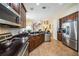 Well-equipped kitchen features dark cabinets and stainless-steel appliances at 742 Seneca Trl, St Cloud, FL 34772