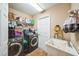Functional laundry room featuring a washing machine, dryer, storage shelves, and a utility sink for added convenience at 742 Seneca Trl, St Cloud, FL 34772