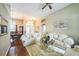 Spacious living room features hardwood floors, a ceiling fan, and natural light at 742 Seneca Trl, St Cloud, FL 34772