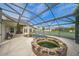Scenic view of a large inground kidney shaped pool enclosed within a screened lanai at 742 Seneca Trl, St Cloud, FL 34772