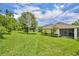 Expansive backyard with mature trees, lush landscaping and views of the surrounding properties at 7834 Minutemen Loop, Winter Garden, FL 34787