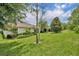 Picturesque backyard with mature trees, lush landscaping, and a view of the back of the home at 7834 Minutemen Loop, Winter Garden, FL 34787
