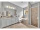 Bright bathroom with white vanity, garden tub and glass enclosed shower at 7834 Minutemen Loop, Winter Garden, FL 34787