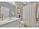 Well-lit bathroom features a white vanity with modern fixtures and a shower with tile surround at 7834 Minutemen Loop, Winter Garden, FL 34787